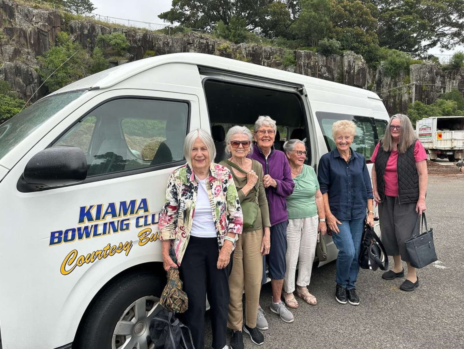 A Group Of Older Women Are Standing In Front Of A White Van — Burnetts On Barney in Kiama, NSW