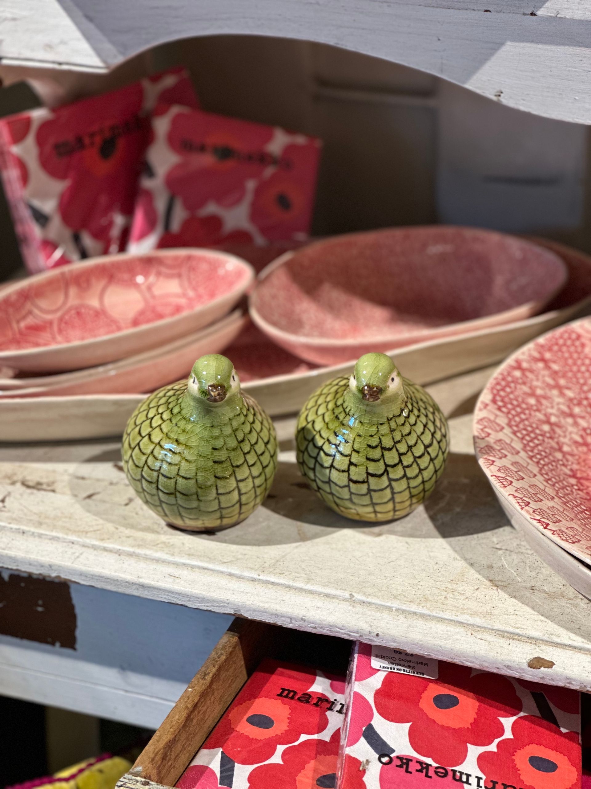 A Shelf With Pink Bowls And Green Salt And Pepper Shakers — Burnetts On Barney in Kiama, NSW