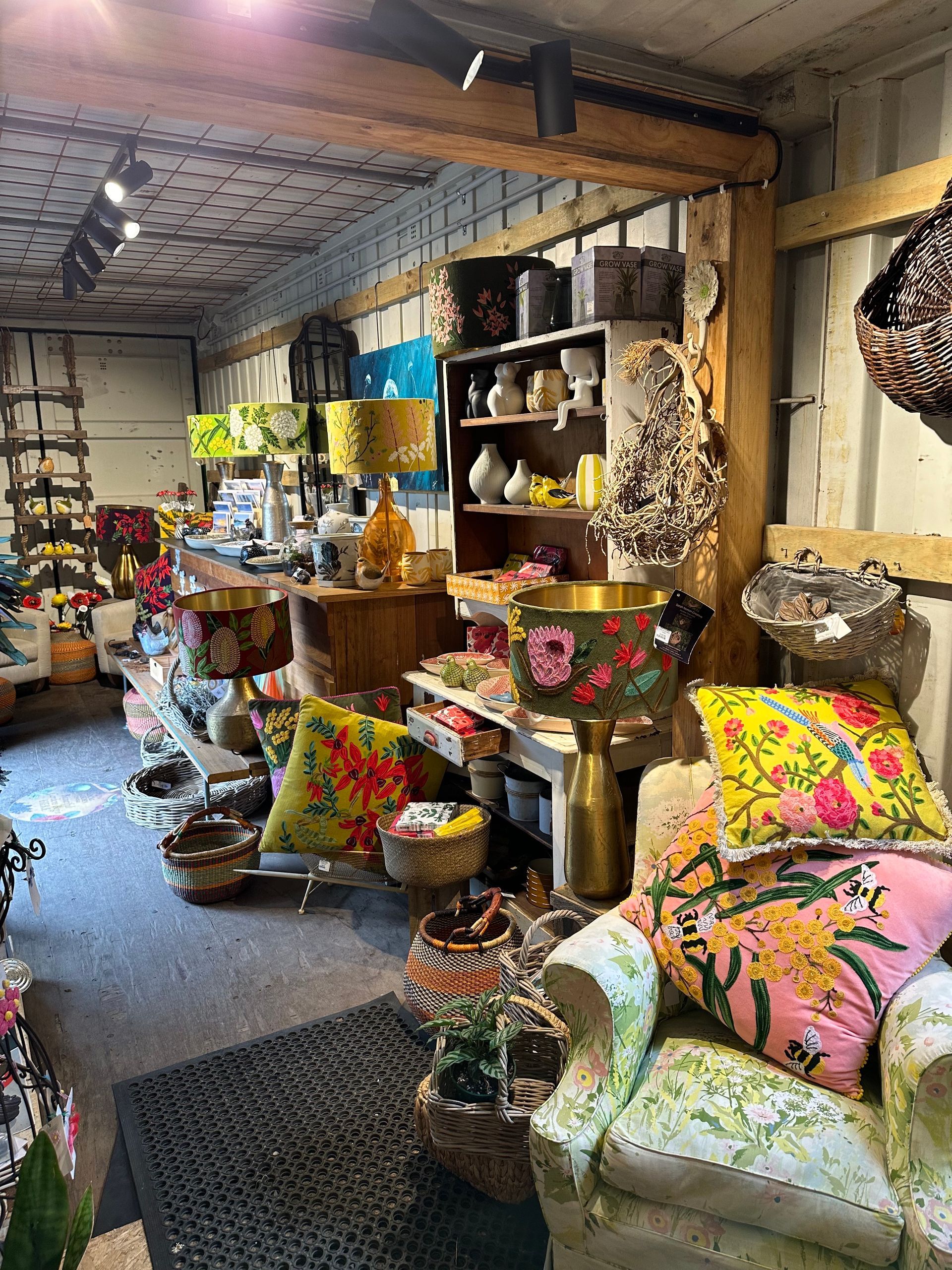 A Room Filled With Lots Of Colourful Pillows And Lamps — Burnetts On Barney in Kiama, NSW
