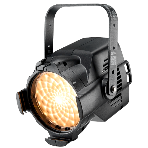 Black stage light with handle, angled lens, emitting warm yellow light.