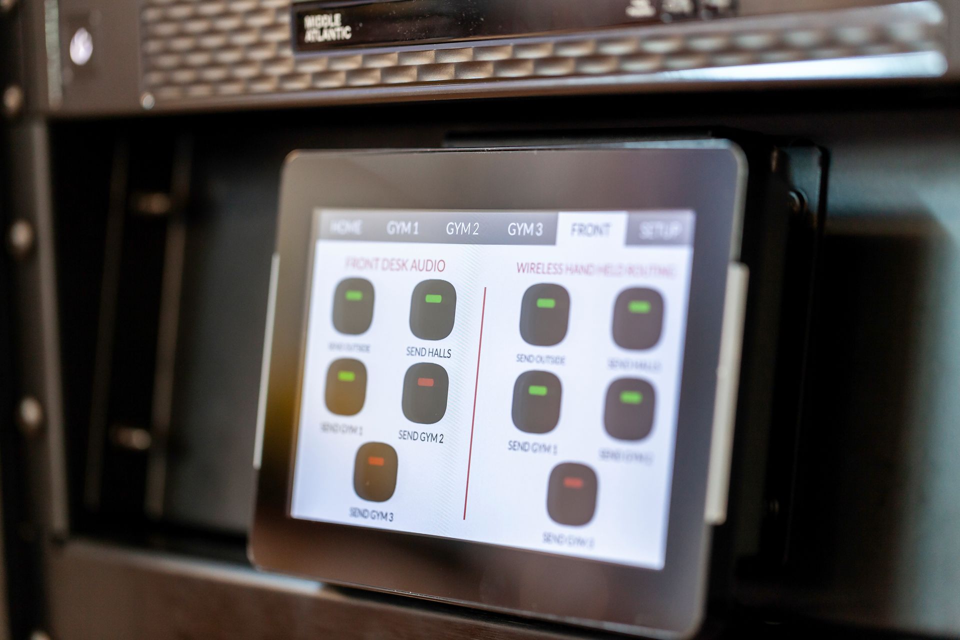 Touchscreen control panel displaying device status within a rack-mounted system.