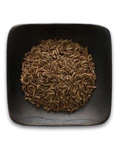 A black bowl filled with brown rice on a white background.