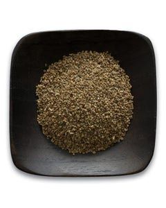 A black bowl filled with ground pepper on a white background.