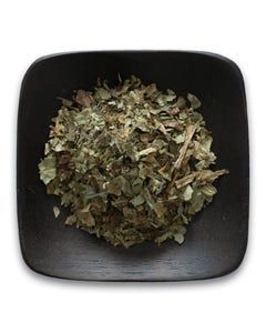 A black bowl filled with dried herbs on a white background.