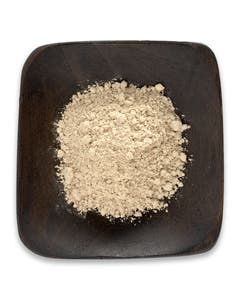 A wooden bowl filled with powder on a white background.