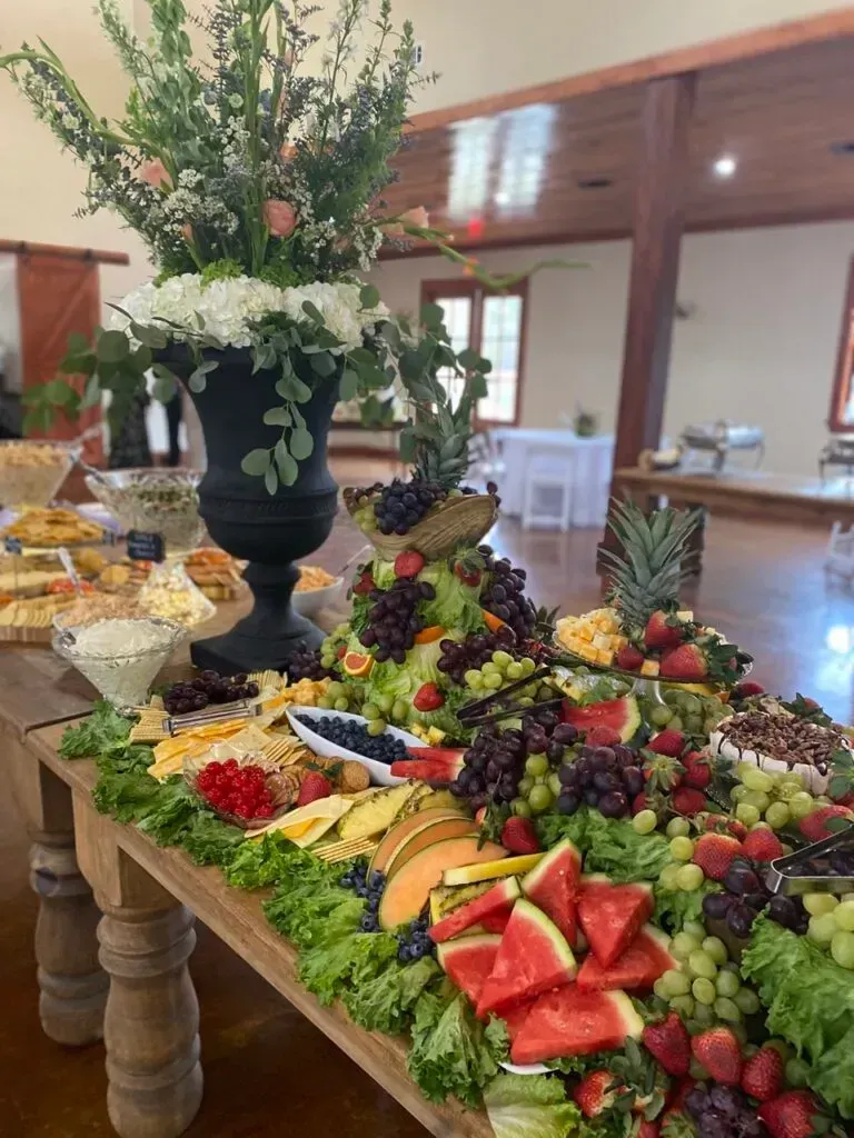 Fruit and dessert buffet on a decorated table at an indoor event