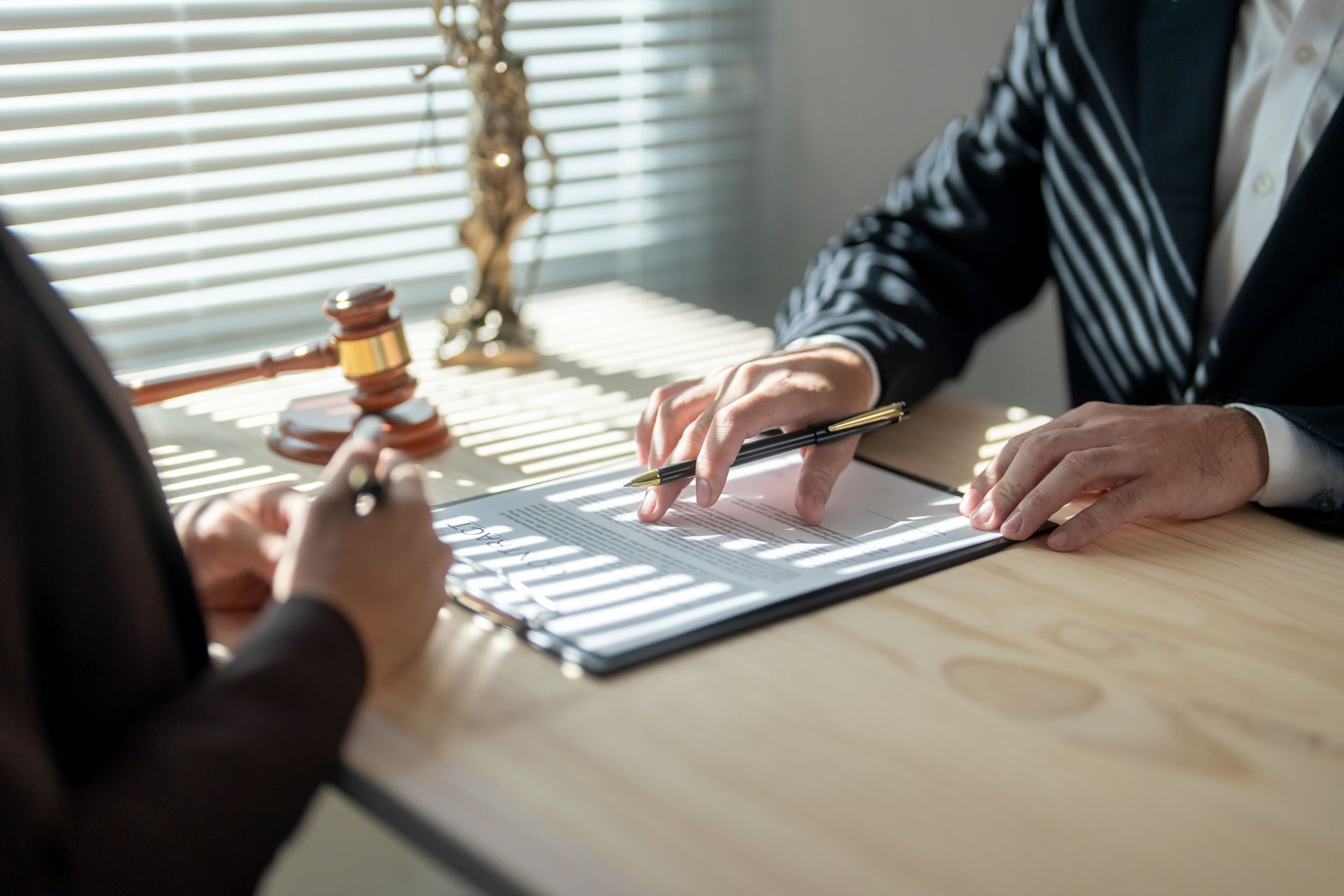 A lawyer is explaining a legal document to a client. A lawyer is explaining a legal document to a client.