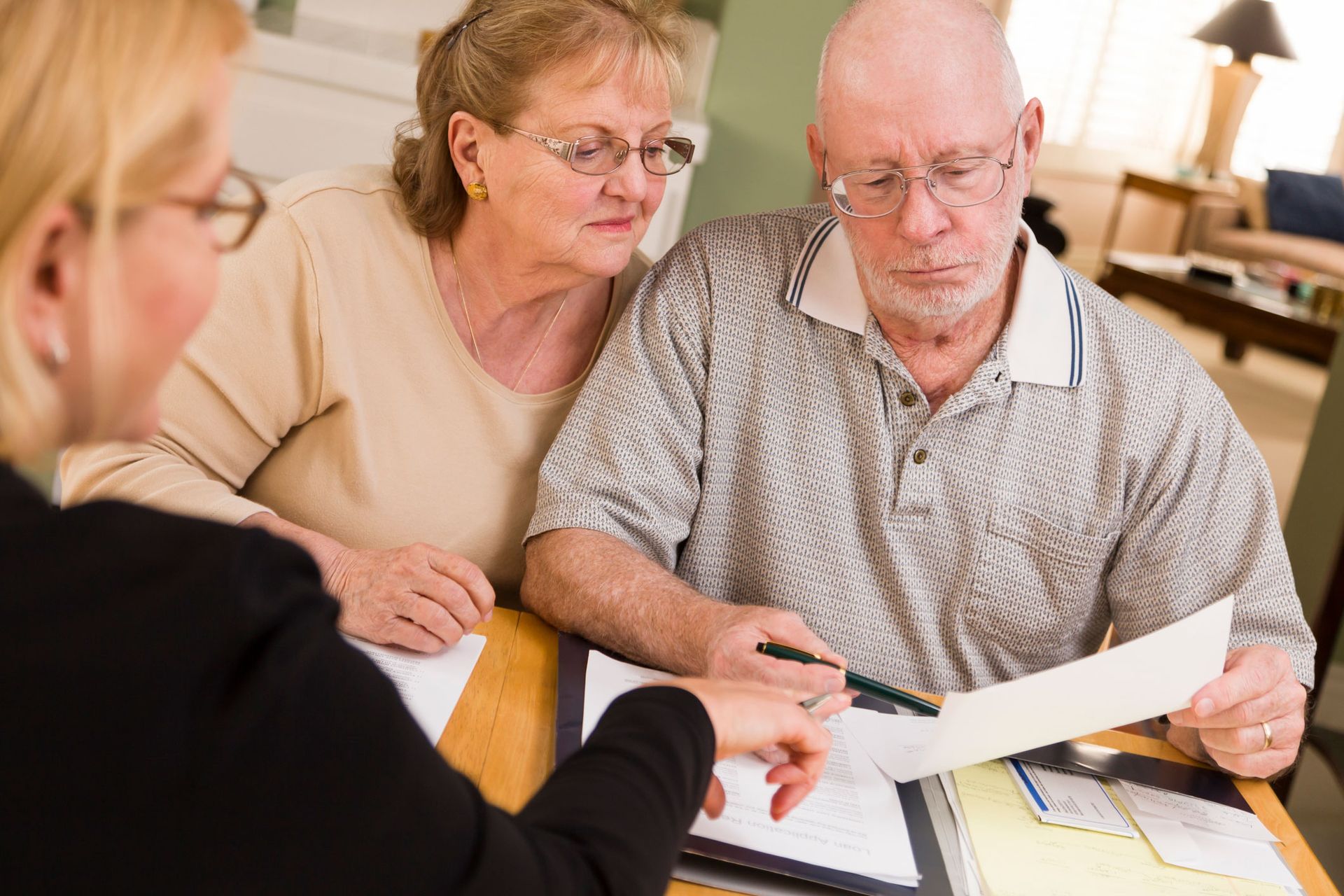 A senior couple reviewing documents at home with a slip and fall lawyer in Camden, NJ, from Borbi, Clancy & Patrizi, LLC.