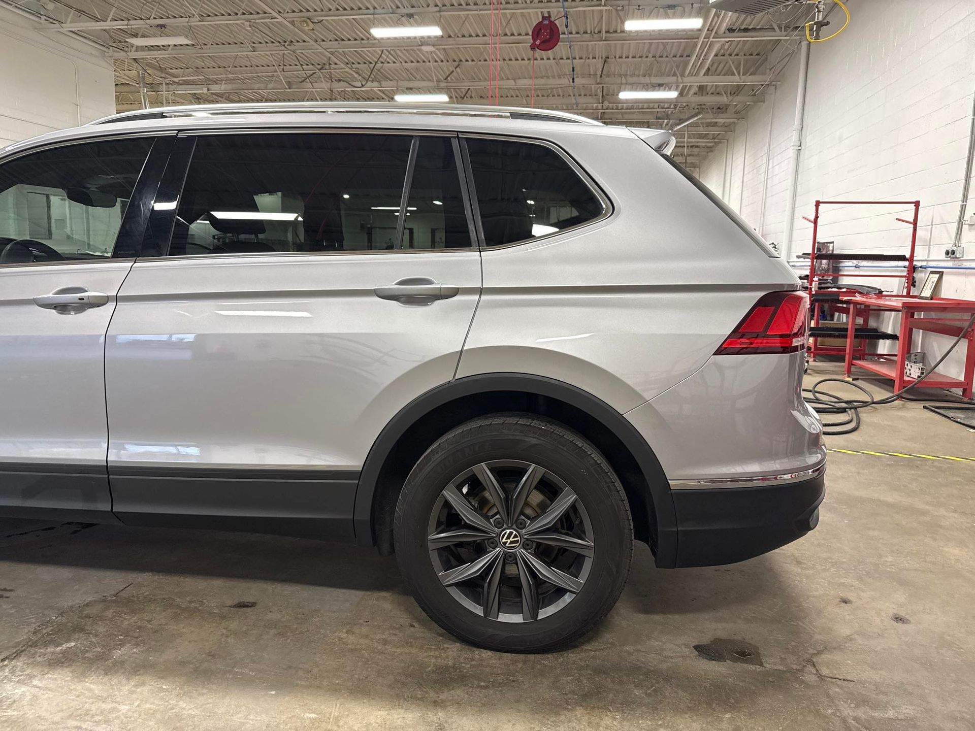 The back of a Silver Tiguan inside of shop
