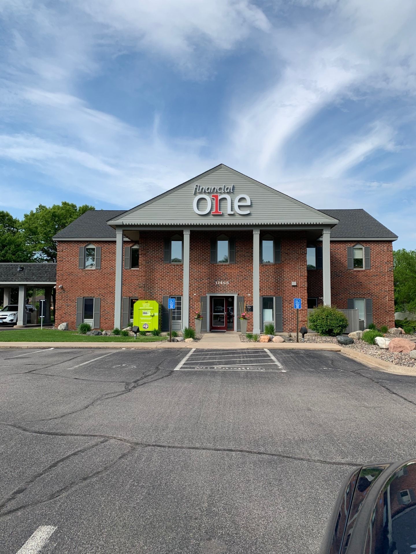 Brick building with love & one sign, two stories, light blue sky. Parking in front. Brick building with love & one sign, two stories, light blue sky. Parking in front.