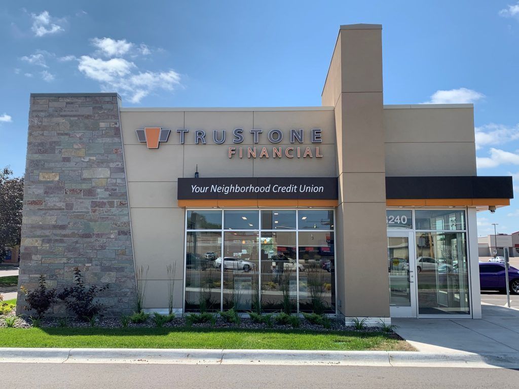 Exterior of a Cornerstone Financial building. Modern design with tan and stone accents, large windows, and signage.