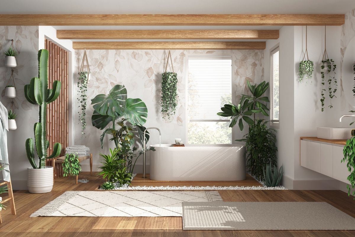 Bright minimalist sunroom with potted plants, wood beams, a window seat, and a woven rug.