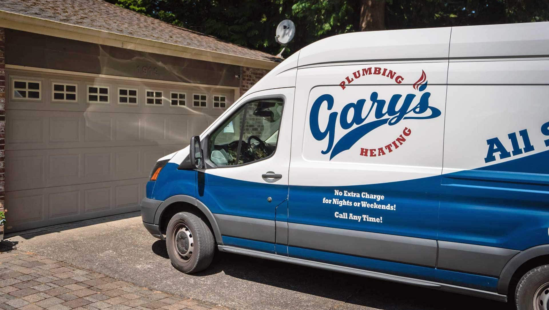 Gary’s Plumbing service van parked by a garage, white and blue with red logo and “All...” text on the side