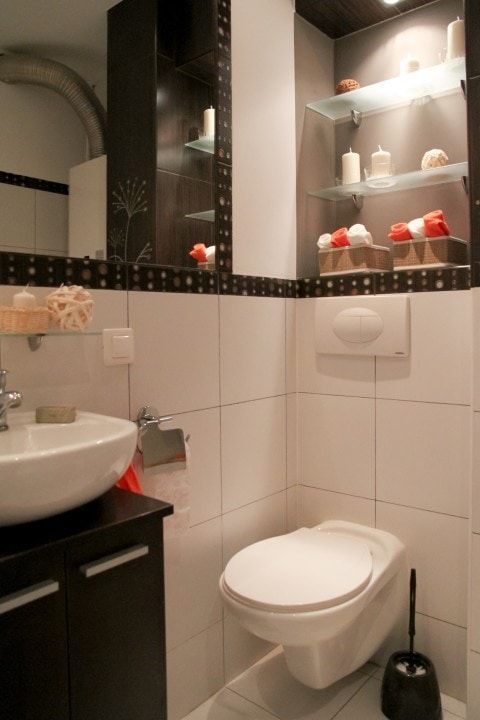 A bathroom with a toilet a sink and a mirror
