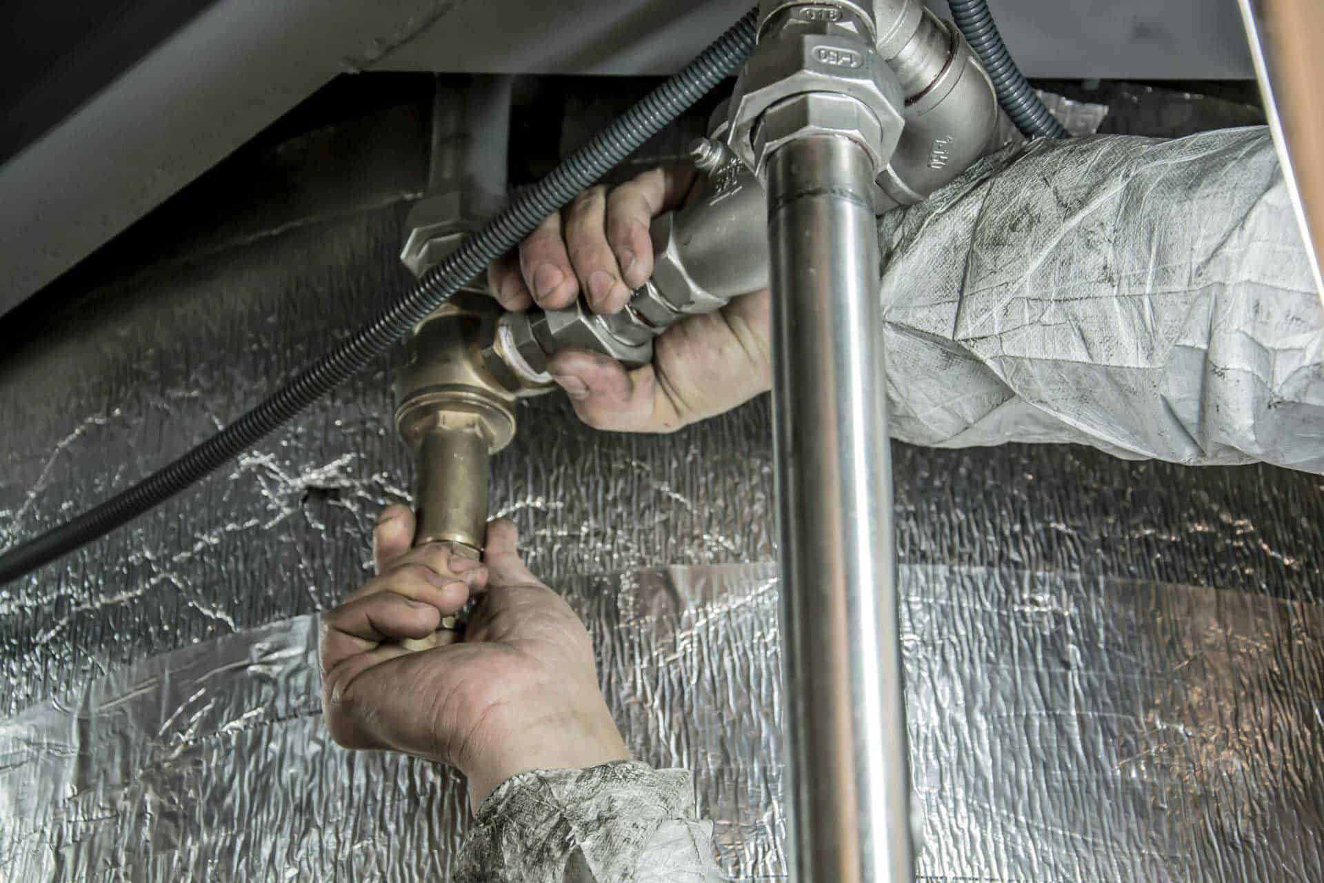 Sealing AC ducts to stop leaks and boost cooling efficiency.