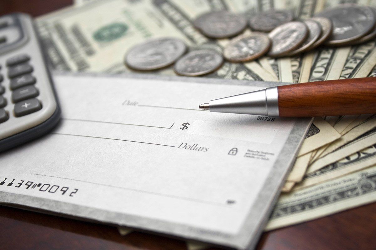 Closeup of Blank Check and Bills — Savannah, GA — Discount Check Casher Closeup of Blank Check and Bills — Savannah, GA — Discount Check Casher