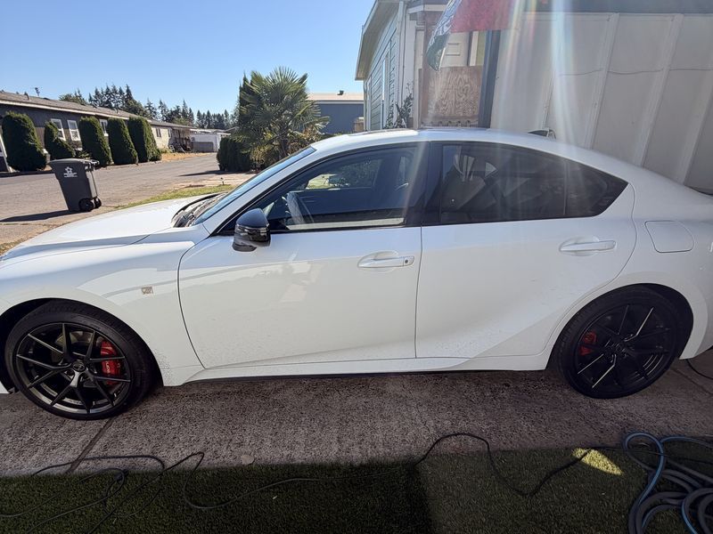 White Lexus IS with light factory windows before tint