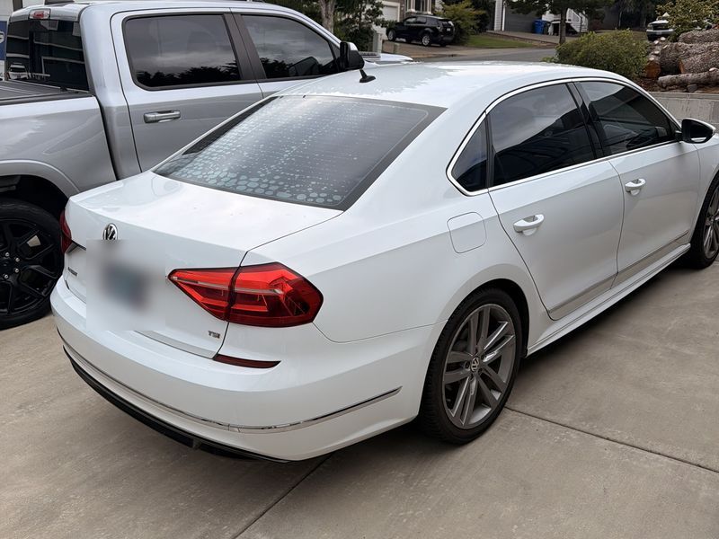 Volkswagen Passat rear window with old, bubbling, failing tint before removal
