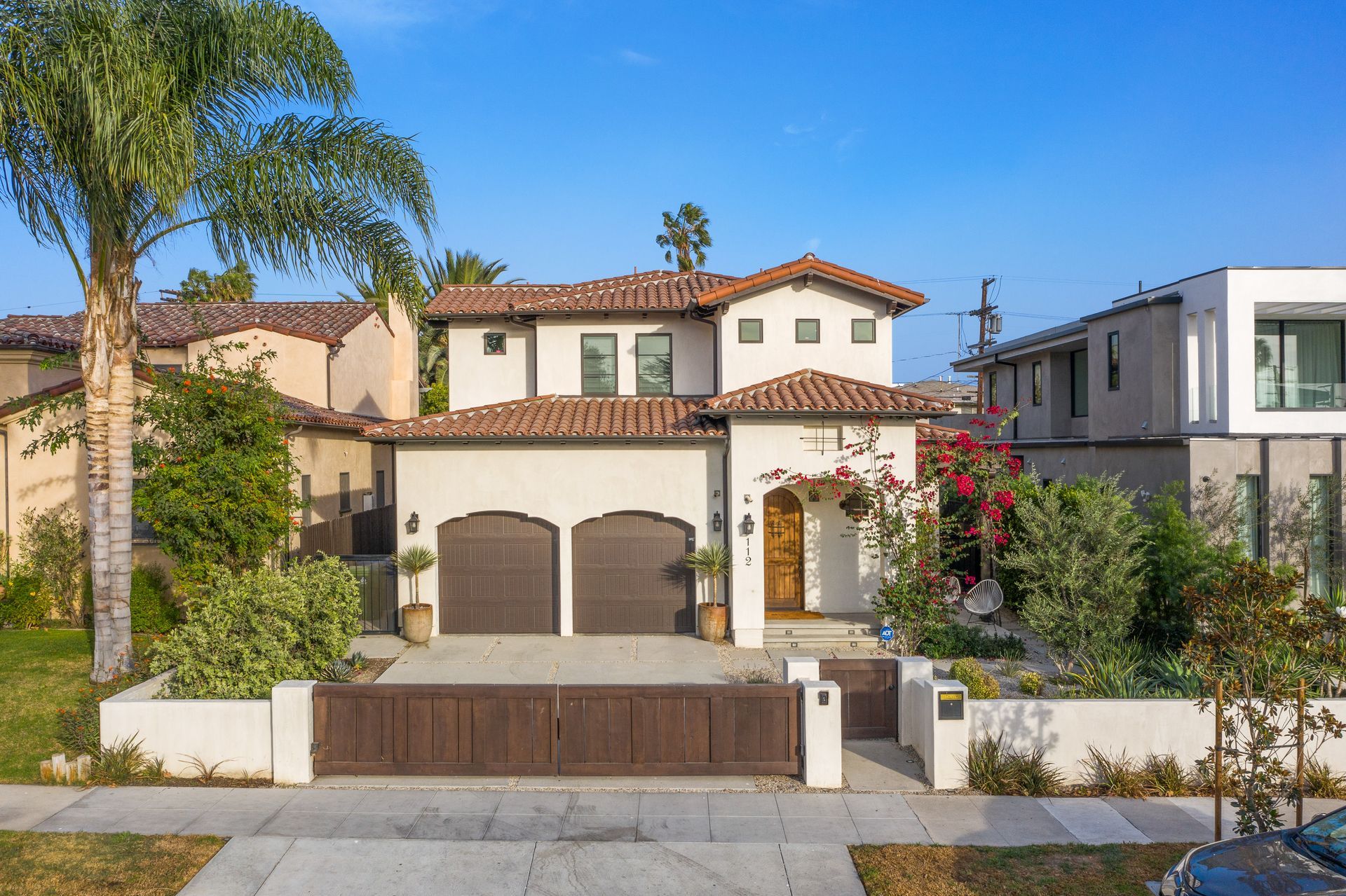 Two-story Spanish-style home with terracotta roof tile double garage and arched entry in Fair Oaks.