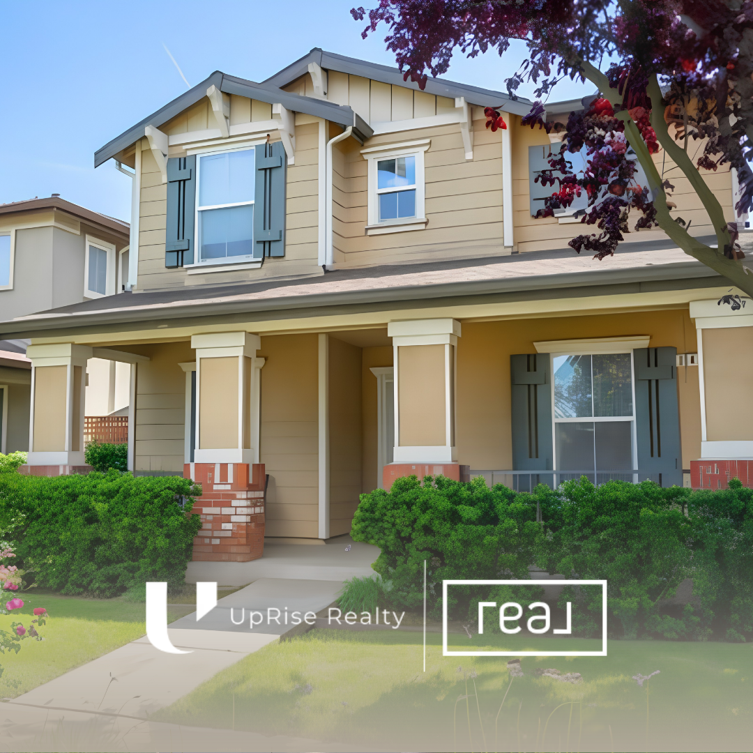 Two-story suburban home with front porch columns and an UpRise Realty logo overlay.