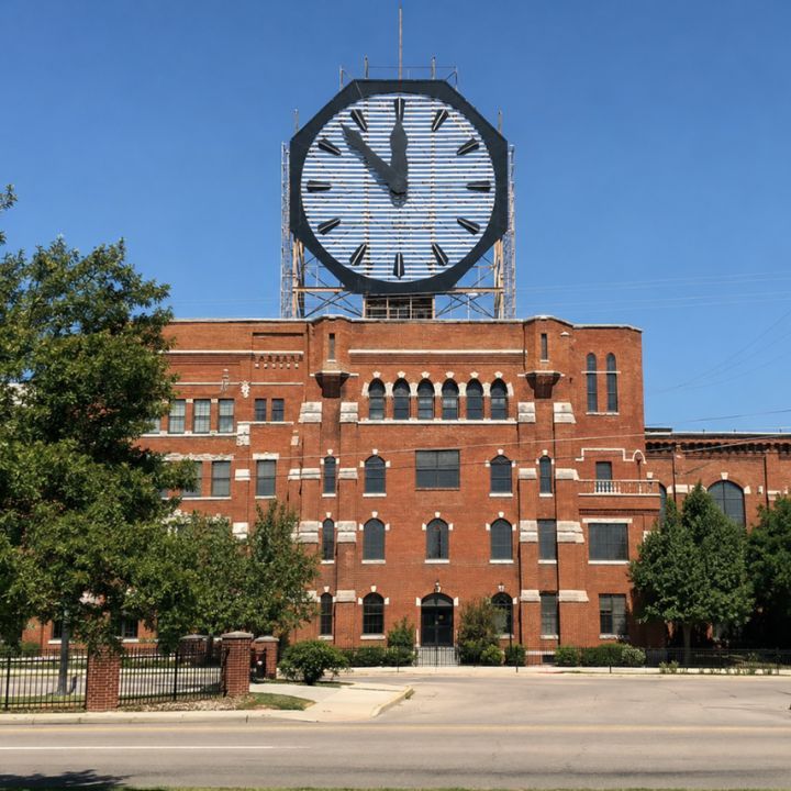 Historic Colgate Clock above a brick industrial building near Clarksville, Indiana.
