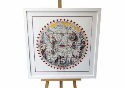 A framed picture of a map of the world is on an easel. Custom picture frames