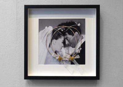 A black and white photo of a bride and groom in a frame.