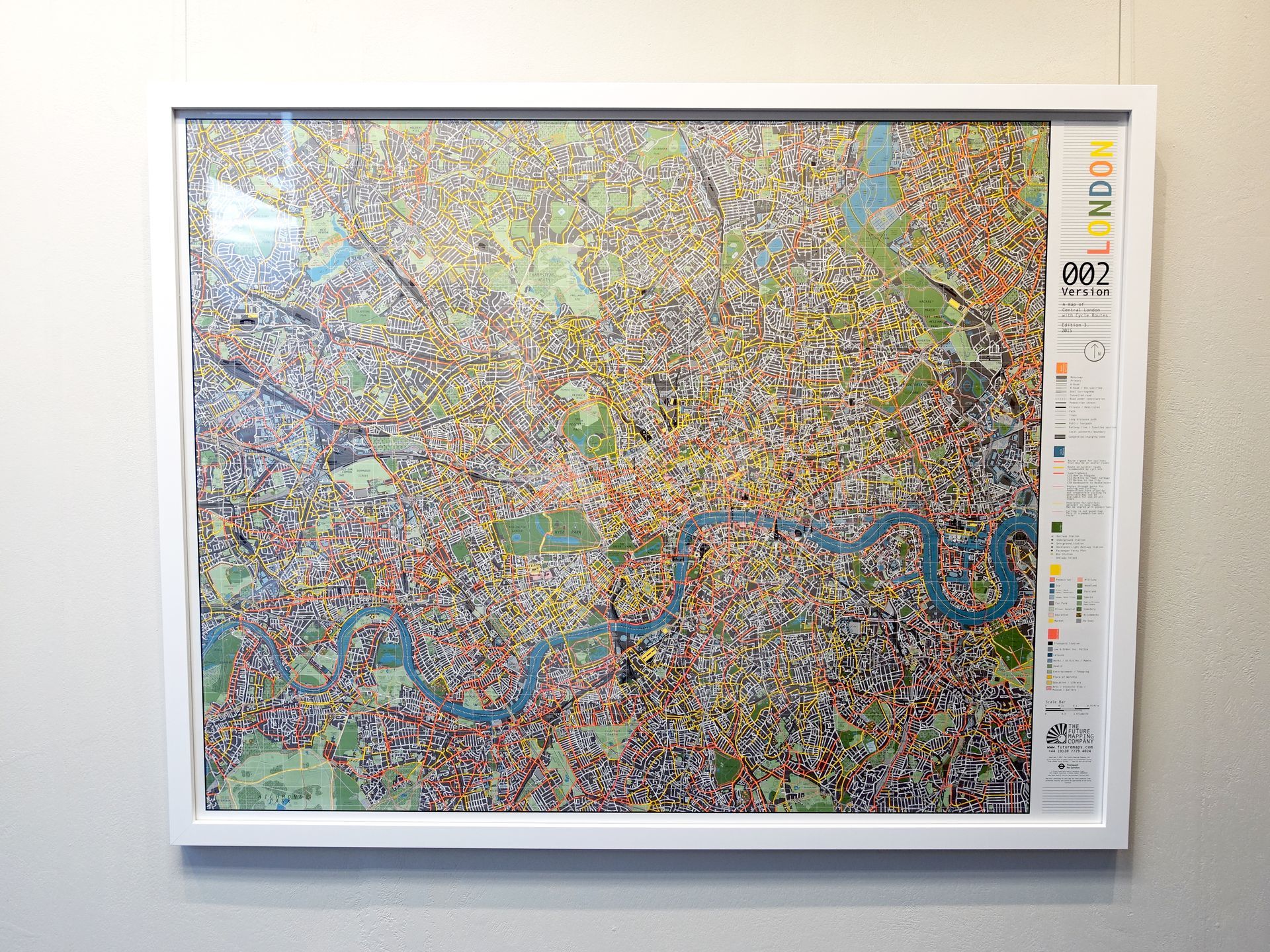 A framed map of london is hanging on a wall. custom picture framing Fulham.