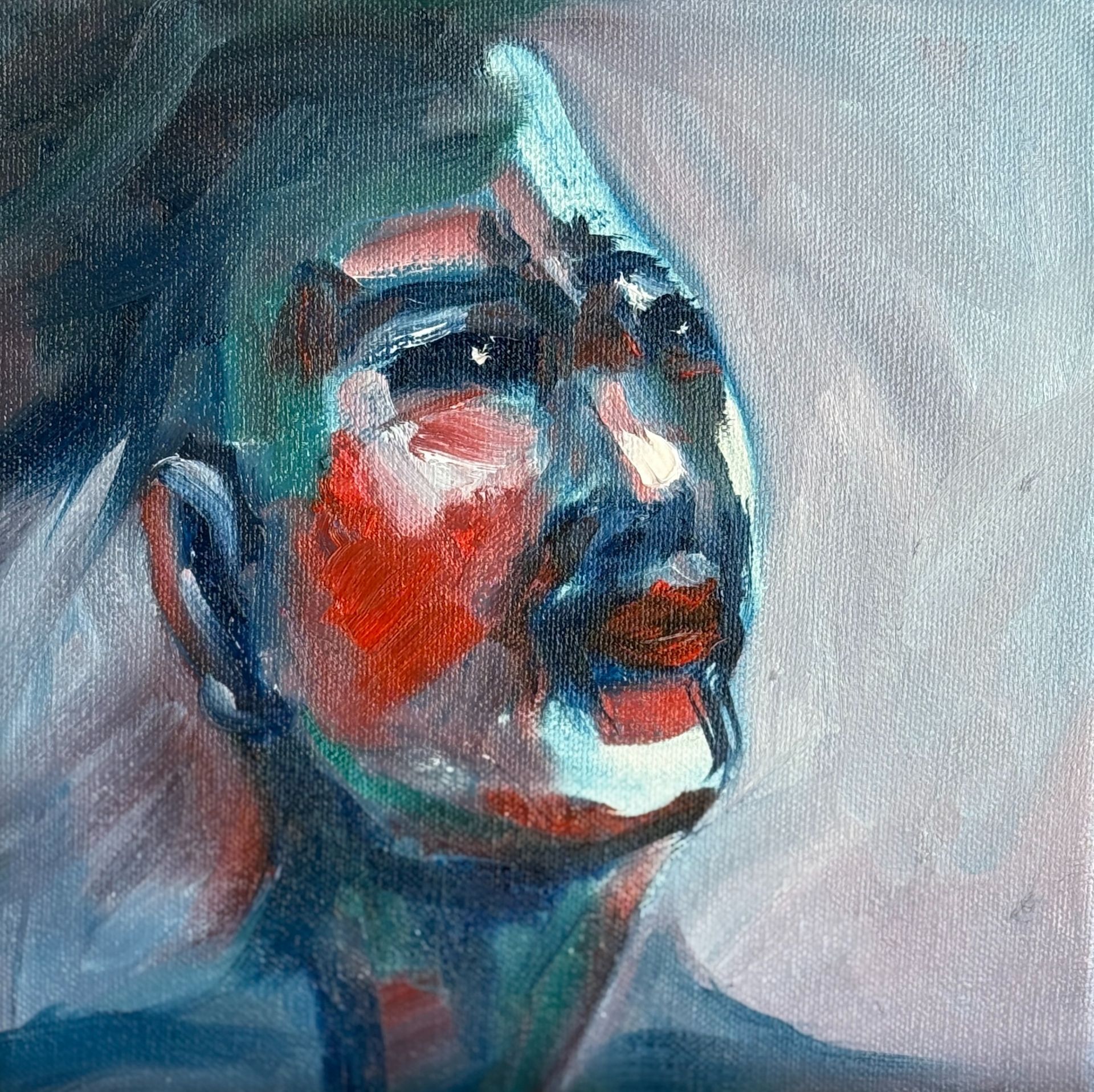 Abstract geschilderd portret van een gezicht in blauw, rood en wit, dat naar boven kijkt tegen een grijze achtergrond.