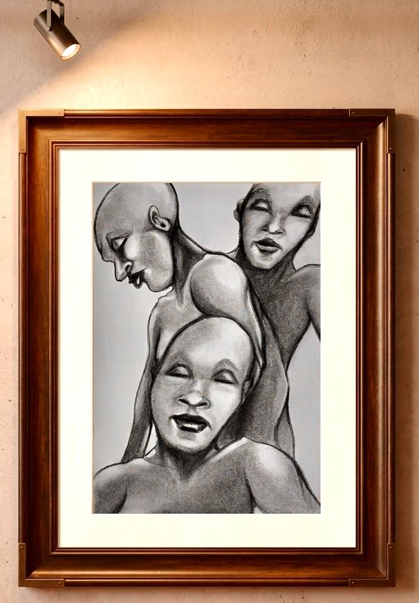 Black-and-white charcoal portrait of three stylized faces in a wooden frame on a wall.