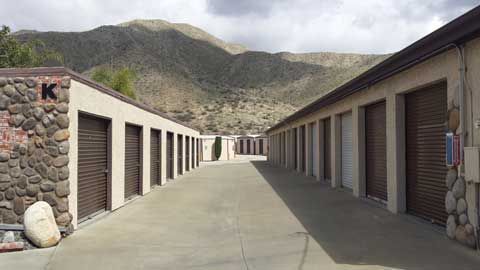 A row of storage units with mountains in the background.