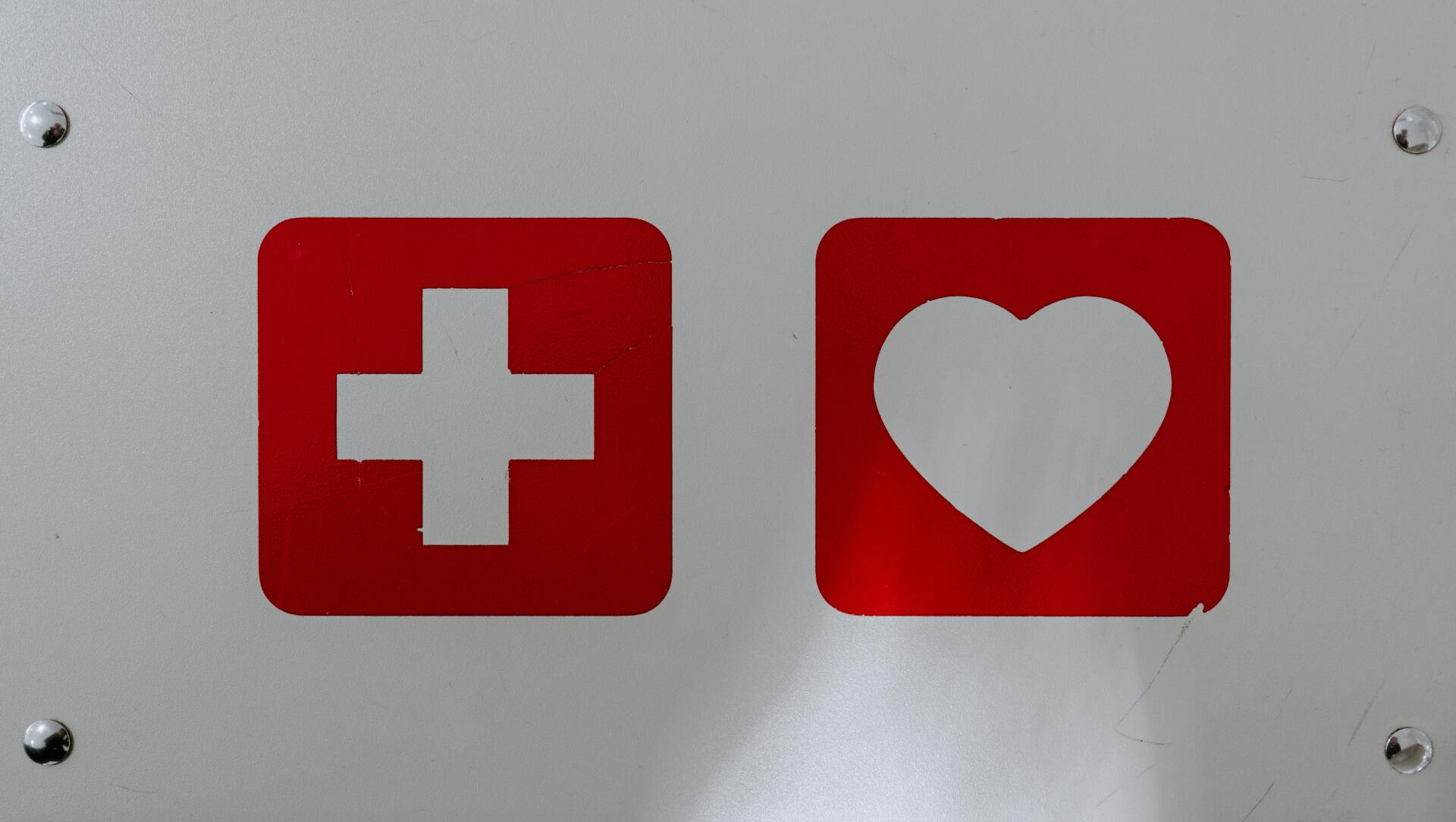 A sign with a cross and a heart on it