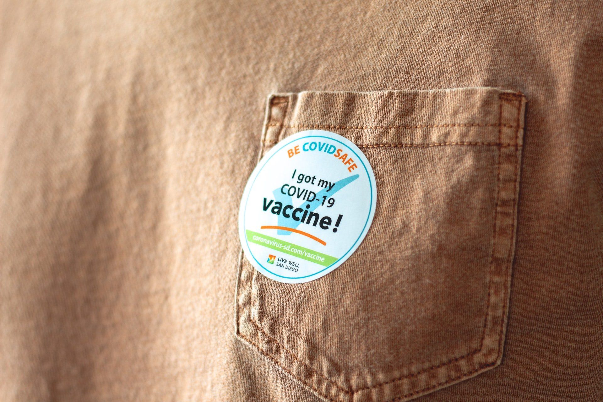 A sticker on a shirt that says `` i got my covid-19 vaccine ''