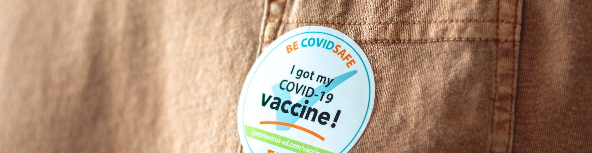 A close up of a sticker on a shirt that says `` i fully vaccinated ''.