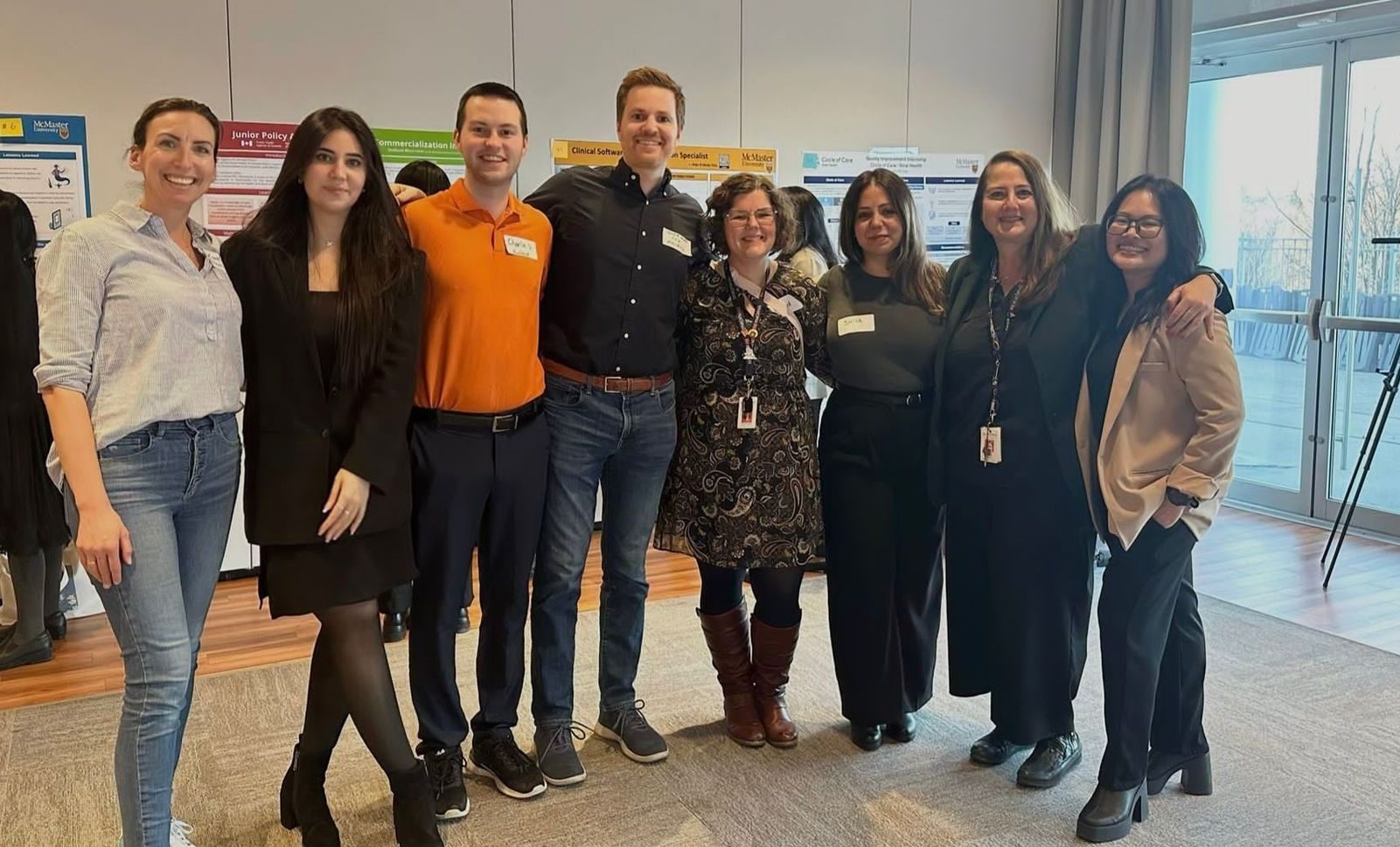A group of people are posing for a picture together in a room.