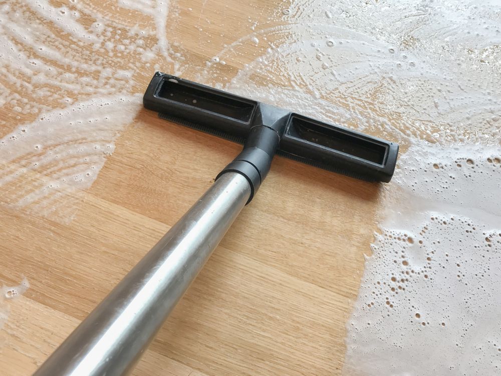 Vacuum Cleaner Head Removing Soapy Water From A Wood Floor —Your Expert Cleaners in Toowoomba
