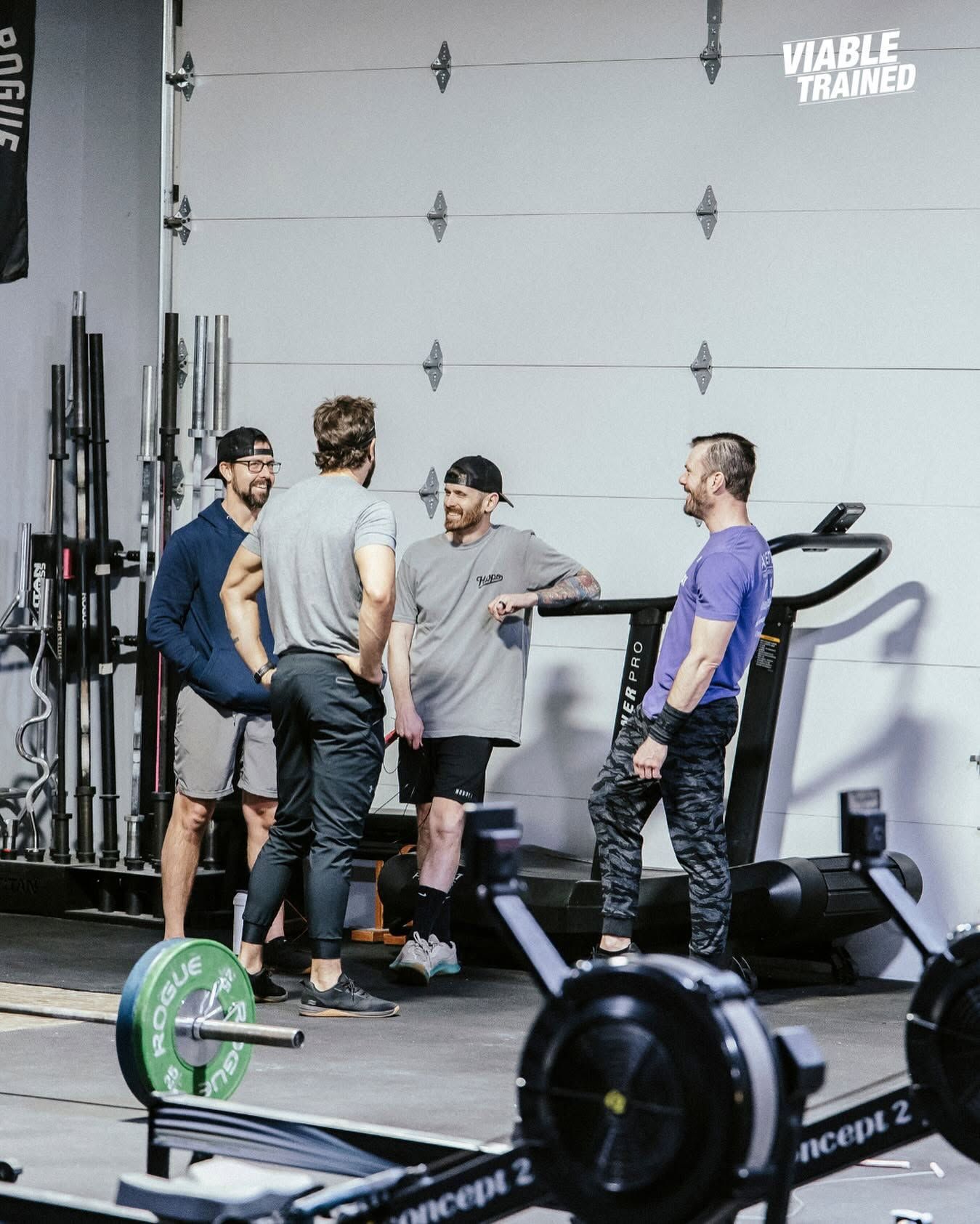 Man lunging in a gym, exercising beside red weight equipment and mirrors at the best CrossFit gym in Sioux Falls, SD.