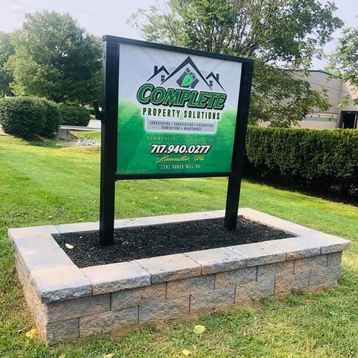 A sign that says complete property solutions on it