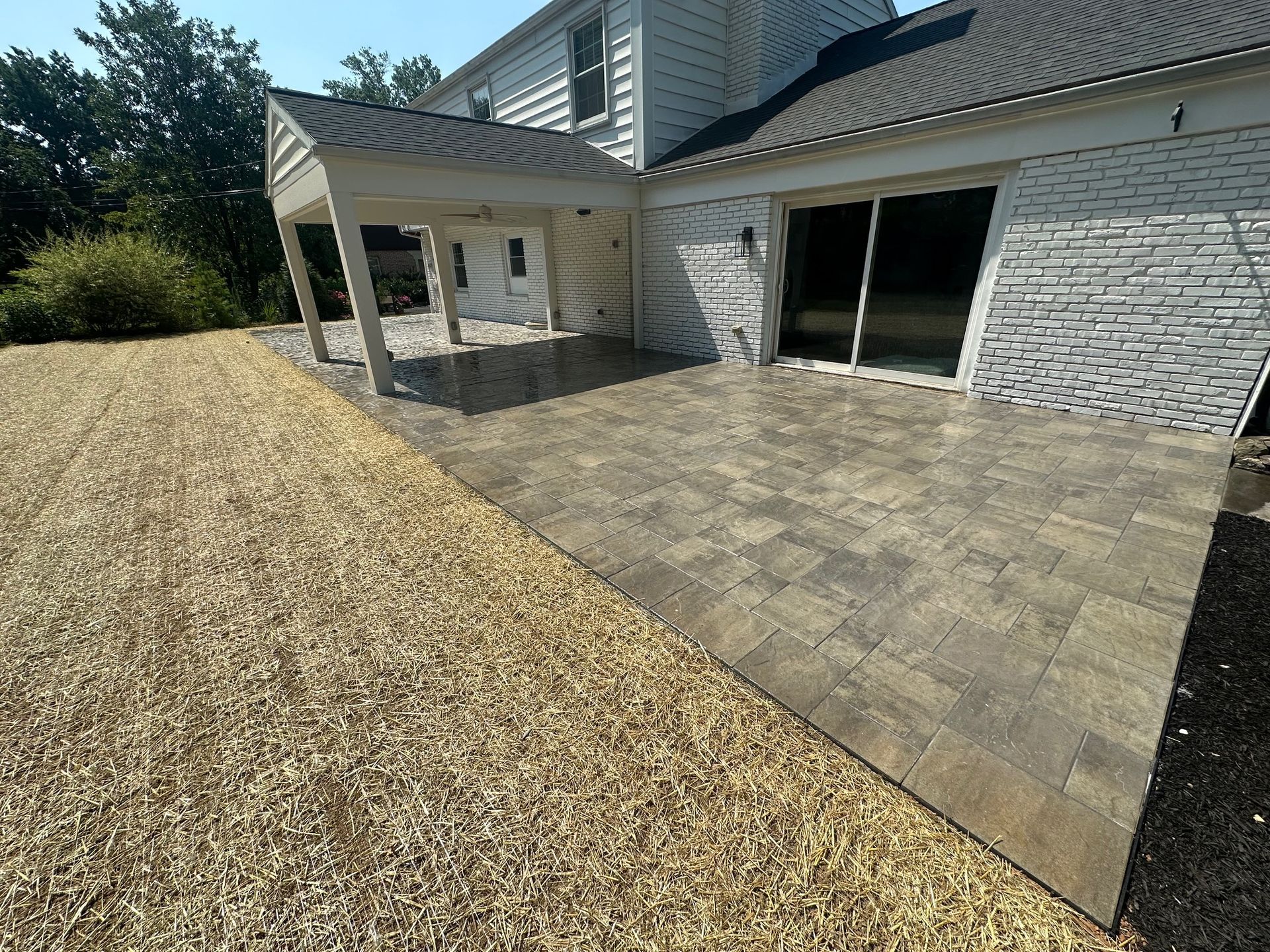 A house with a new paver patio installed by complete property solutions of Lancaster PA