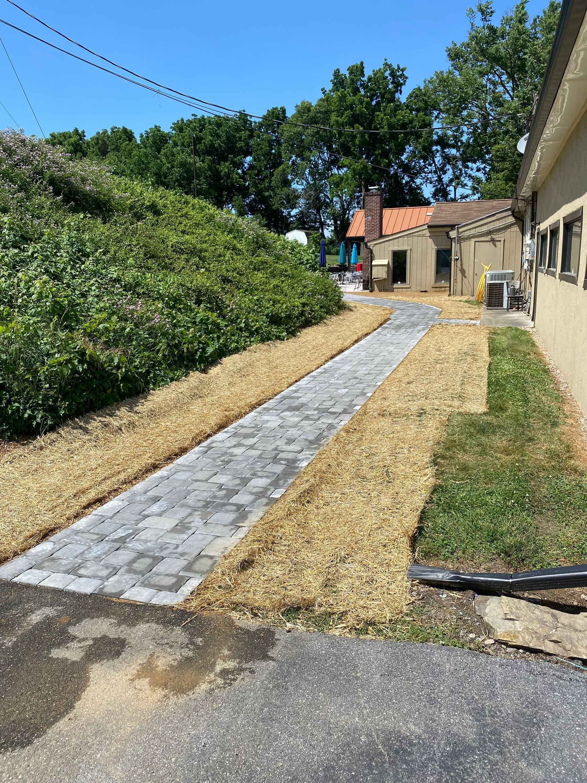 A sidewalk is being built in front of a house.