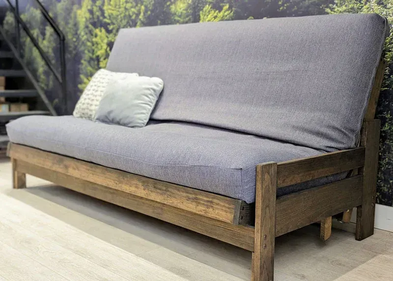 A living room with a couch , table , and rug.