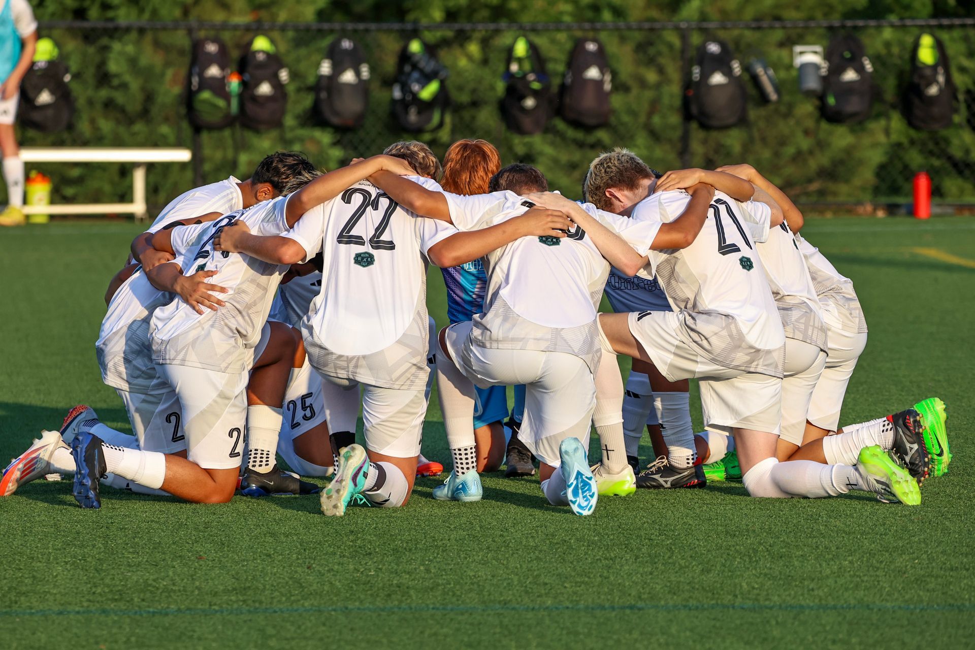 Soccer team huddled on the field for United Futbol Academy