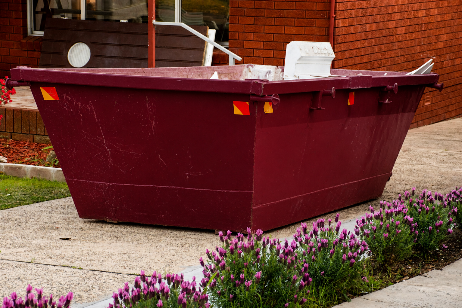Skip bin placed outside a Sunshine Coast home filled with household and renovation waste