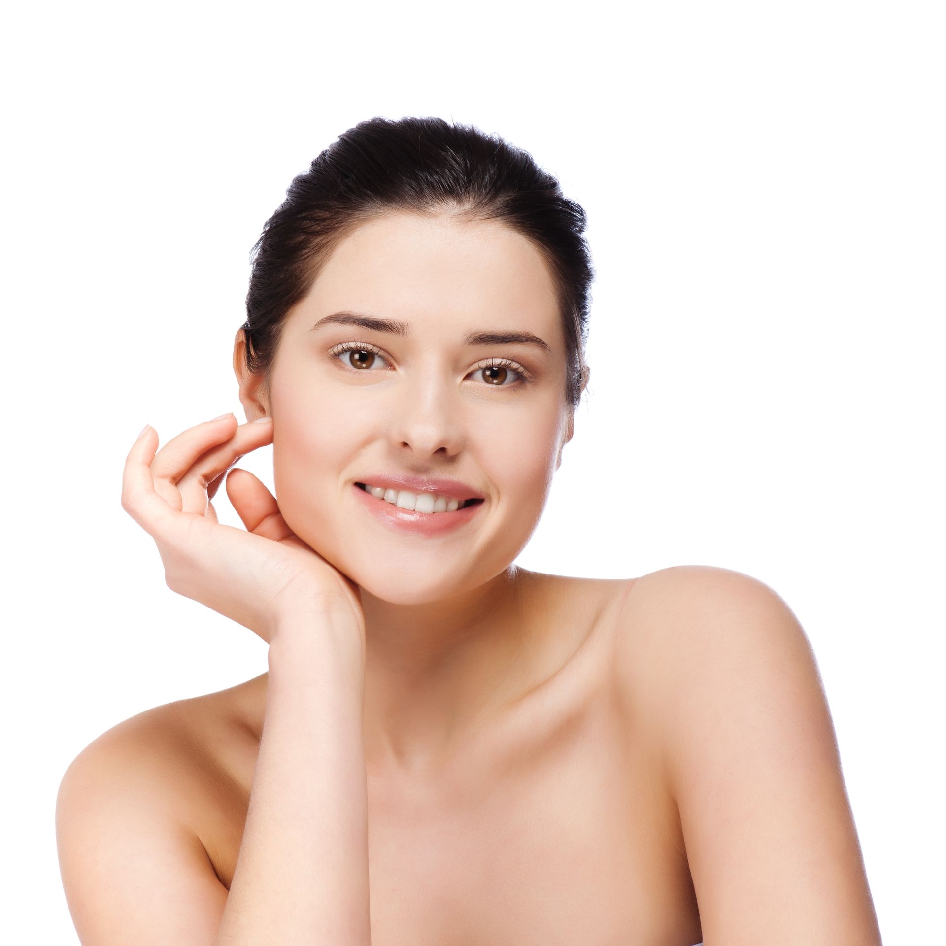A woman without a shirt is smiling and touching her face with her hand.