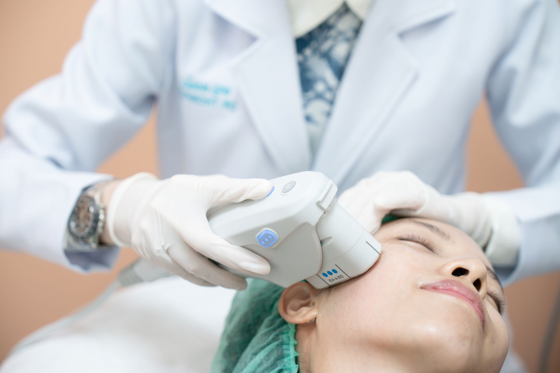 A woman is getting a facial treatment from a doctor.