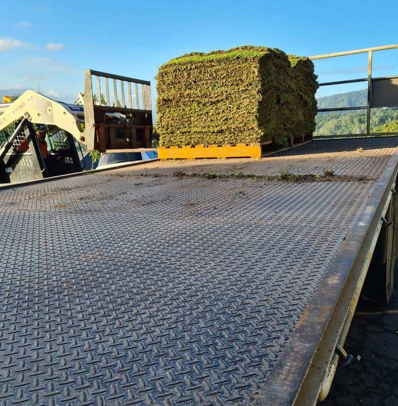 A Large turfs Is On The Back Of A Flatbed Truck — Barron River Lawns In Biboohra, QLD