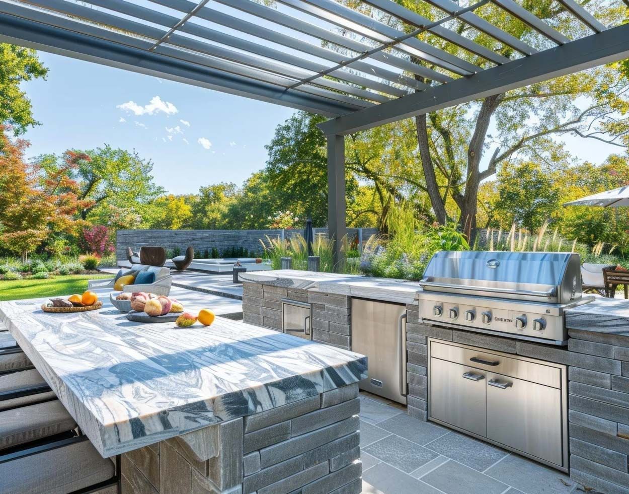 Outdoor patio with stone grill island, dining table, and pergola in a sunny garden