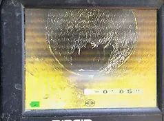 A camera is taking a picture of a hole in a pipe.