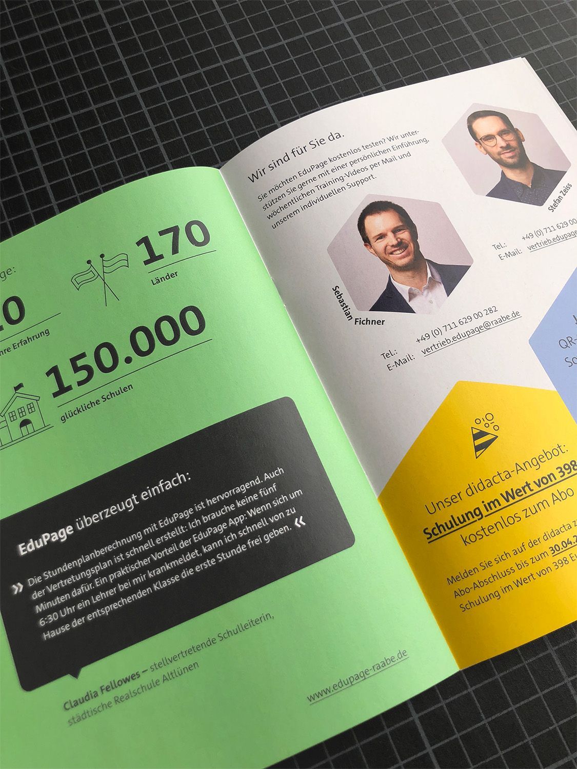DIN A5-Flyer aufgeblättert: mit grünen, gelben, hellblauen sowie anthraziten Farben auf weißem Papier, mit Gestaltungselementen Polygonen sowie einer Zahlenwolke.