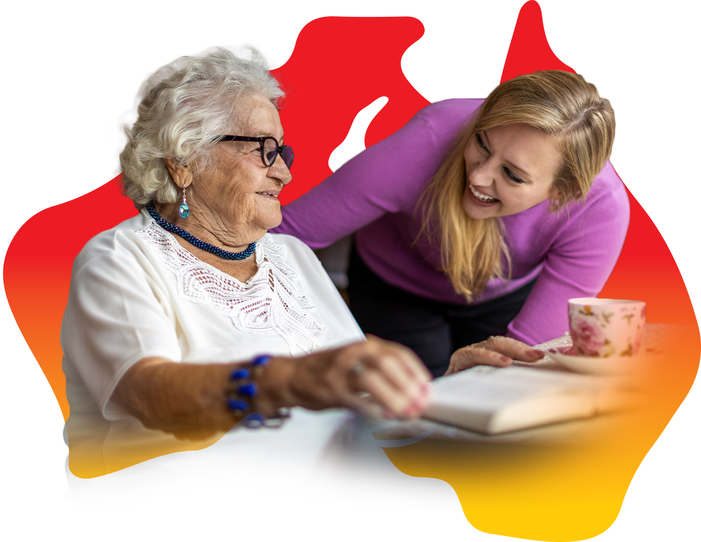 A young woman is talking to an older woman while she's holding a book